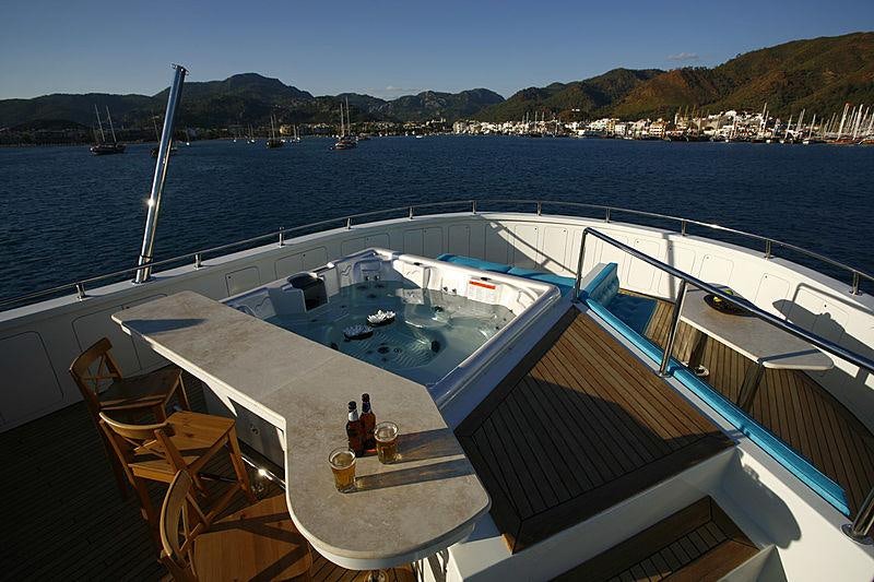 a deck with a large ship in the water aboard APNA Yacht for Charter