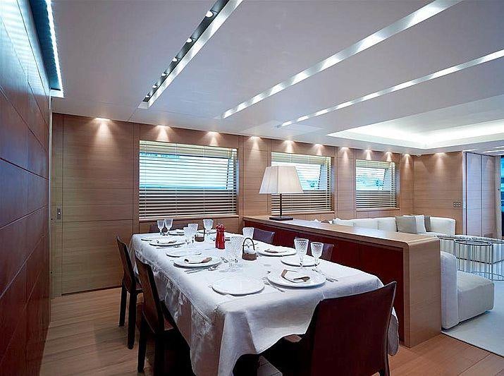 a dining room with a table aboard FELIGO V Yacht for Charter