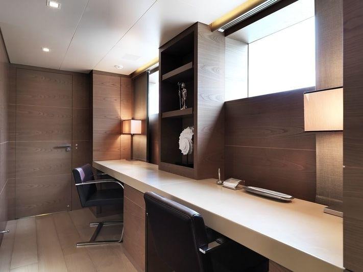 a room with a desk and chairs aboard NAIA Yacht for Charter
