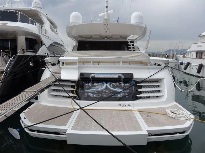 a white yacht in a harbor aboard ASTRO Yacht for Charter