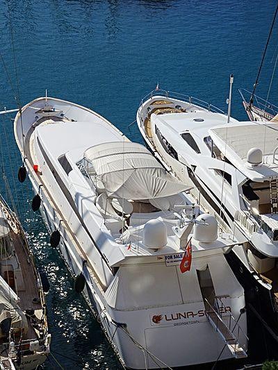 a group of white boats on a dock aboard LUNASEA Yacht for Charter