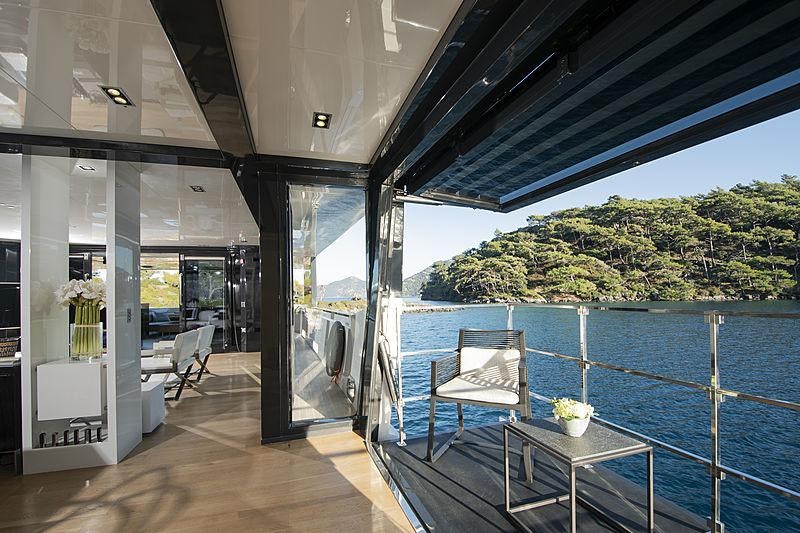 a room with a pool and a deck with a view of the water aboard SUN Yacht for Charter