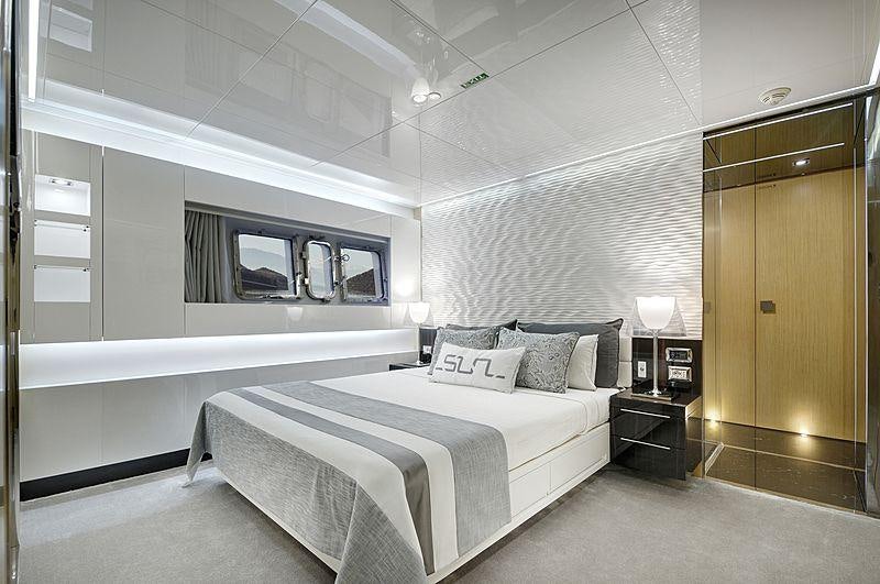 a room with a bed and a window aboard SUN Yacht for Charter