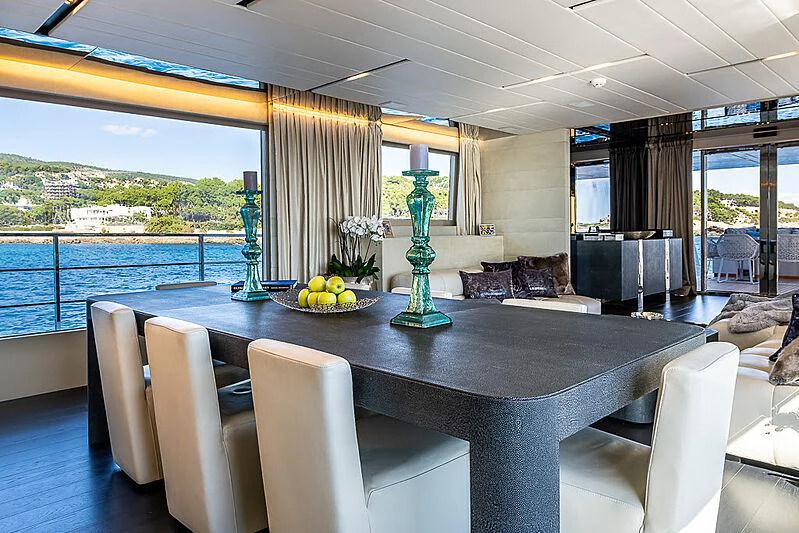 a large table with chairs around it aboard CINQUANTA-50 Yacht for Charter