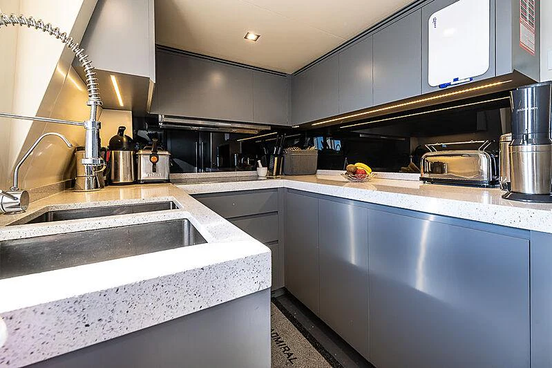 a kitchen with a sink and a microwave aboard CINQUANTA-50 Yacht for Charter