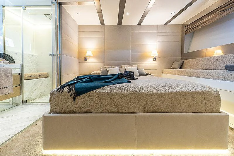 a room with a bed and a door aboard CINQUANTA-50 Yacht for Charter