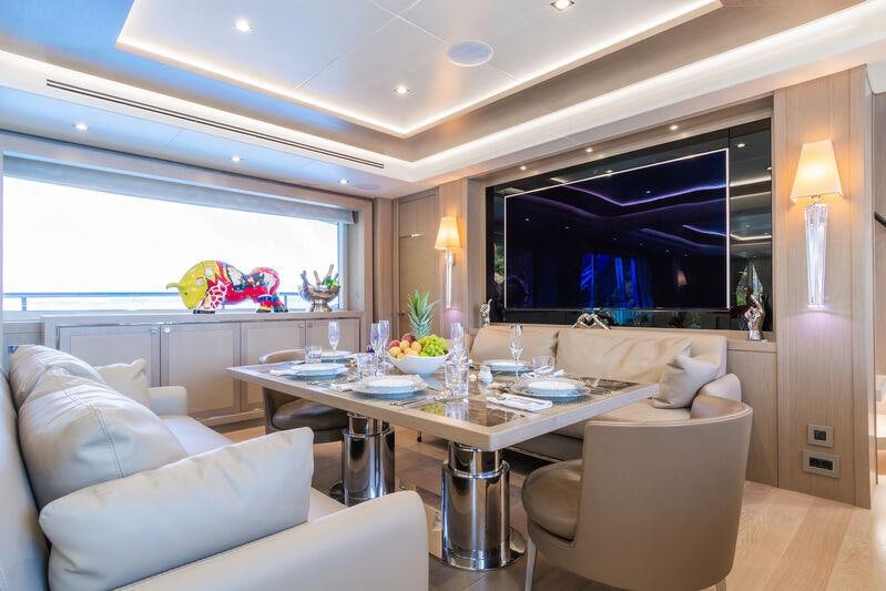 a living room with a table and chairs aboard FREEDOM Yacht for Charter
