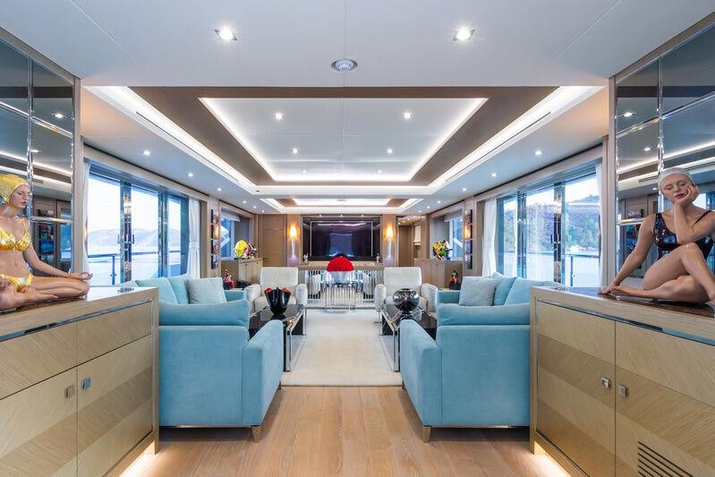 a person sitting in a room aboard FREEDOM Yacht for Charter