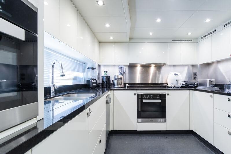 a kitchen with white cabinets aboard FREEDOM Yacht for Charter