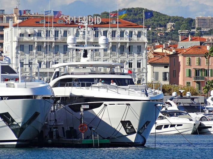 a group of boats in a harbor aboard RIVIERA LIVING Yacht for Charter