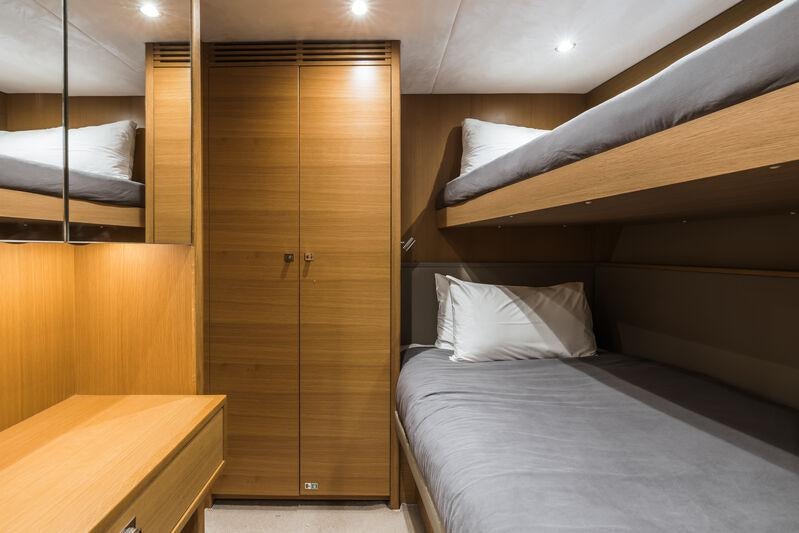 a room with a bed and a closet aboard RIVIERA LIVING Yacht for Charter