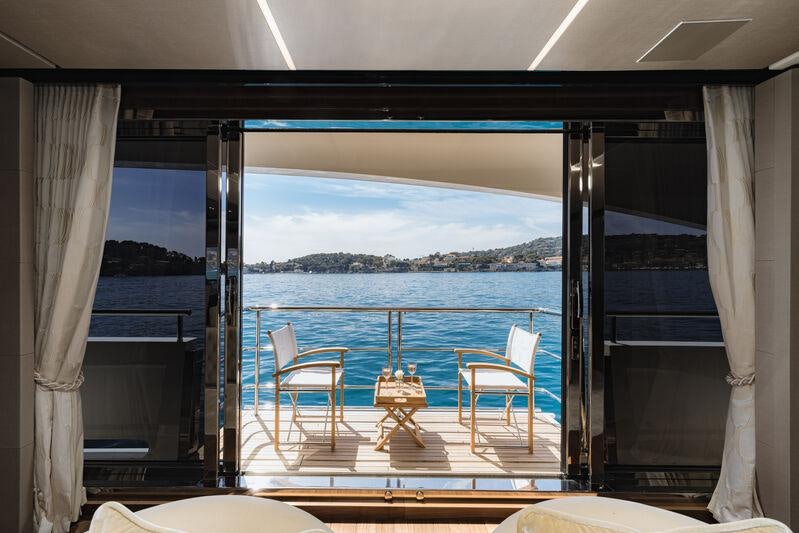 a room with a view of the ocean and the land below aboard RIVIERA LIVING Yacht for Charter
