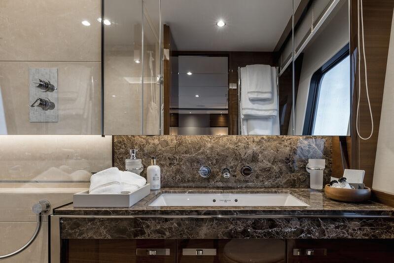 a bathroom with a large marble counter aboard RIVIERA LIVING Yacht for Charter