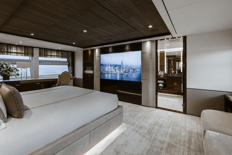 a room with a bed and a tv aboard RIVIERA LIVING Yacht for Charter