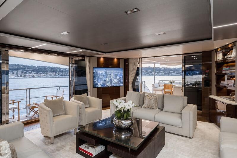 a living room with a large window aboard RIVIERA LIVING Yacht for Charter