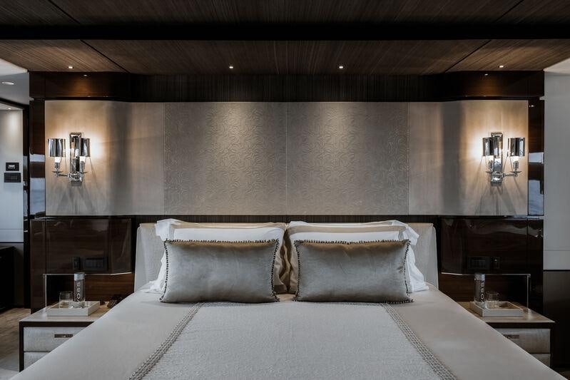 a bed with a white sheet aboard RIVIERA LIVING Yacht for Charter