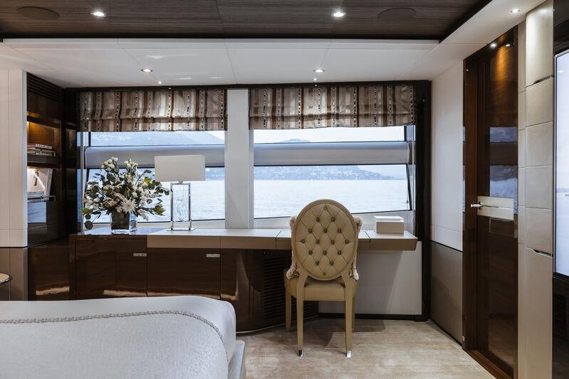 a room with a chair and a bed aboard RIVIERA LIVING Yacht for Charter
