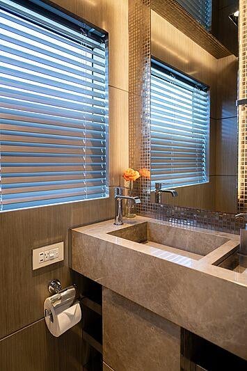 a bathroom with a sink and a window aboard THE PEDDLER Yacht for Sale