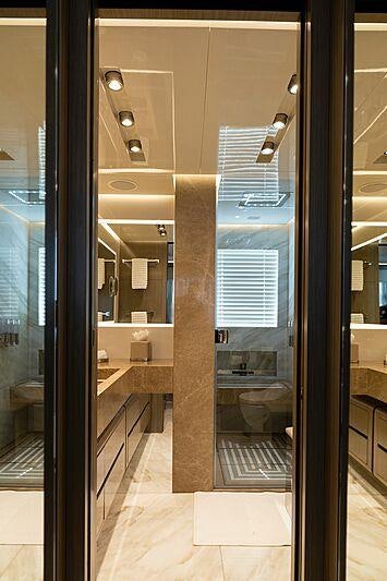 a bathroom with a glass shower aboard THE PEDDLER Yacht for Sale