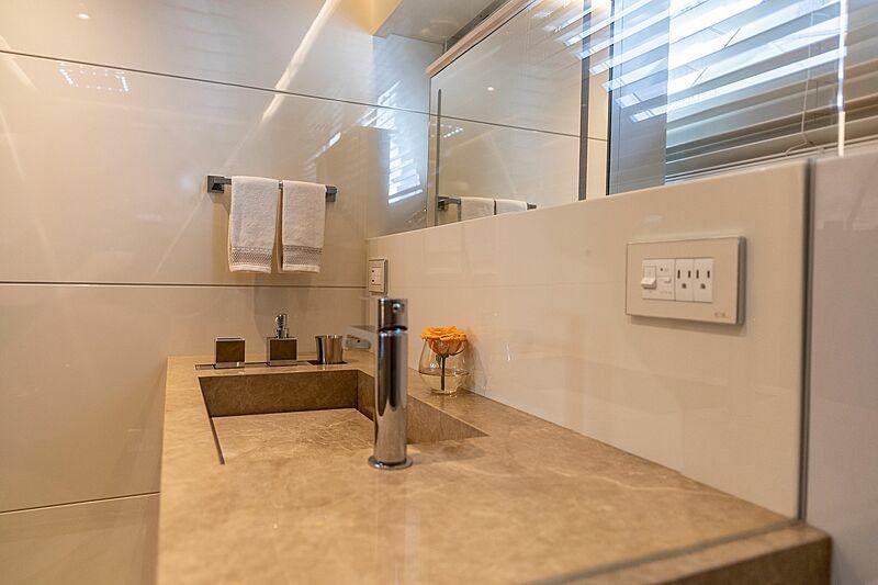 a bathroom with a countertop sink and a mirror aboard THE PEDDLER Yacht for Sale