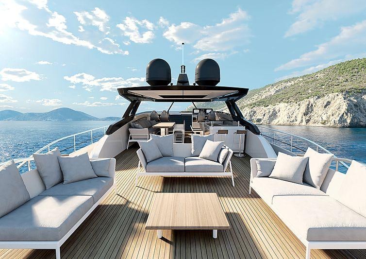 a deck with a large body of water and a large mountain in the background aboard EPIC Yacht for Charter