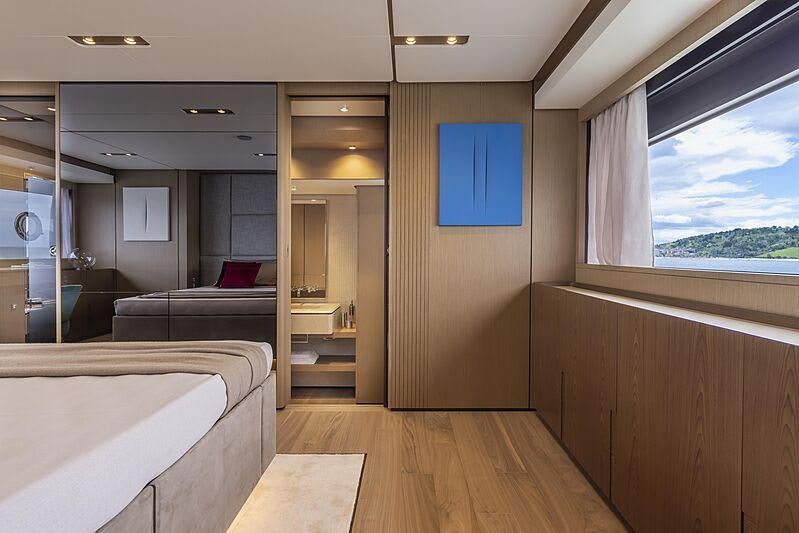 a room with a bed and a desk aboard EPIC Yacht for Charter