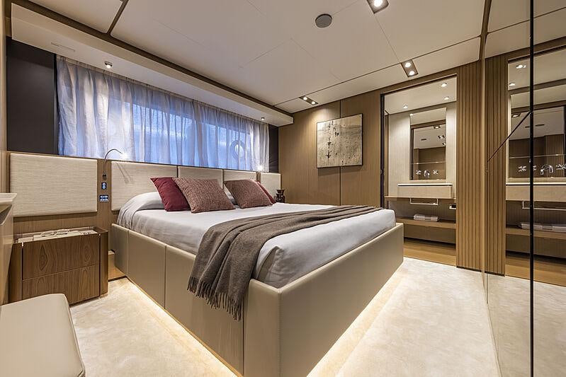 a bedroom with a bed and a desk aboard EPIC Yacht for Charter