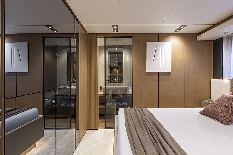 a hotel room with a glass door aboard EPIC Yacht for Charter