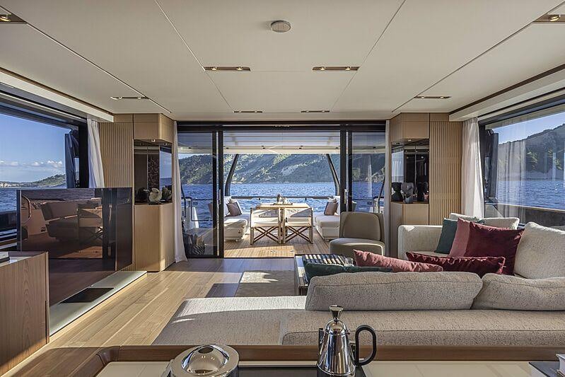 a living room with a large window aboard EPIC Yacht for Charter