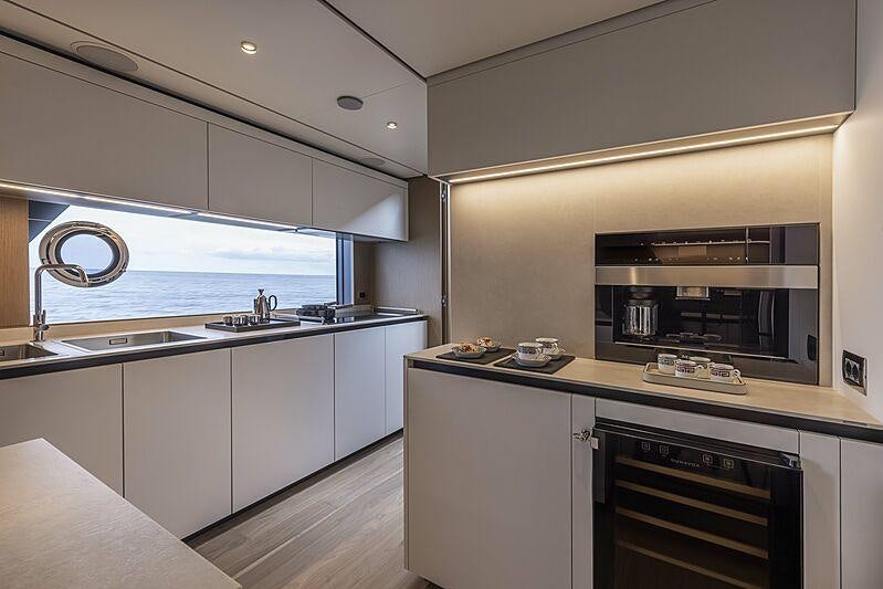 a kitchen with white cabinets aboard EPIC Yacht for Charter
