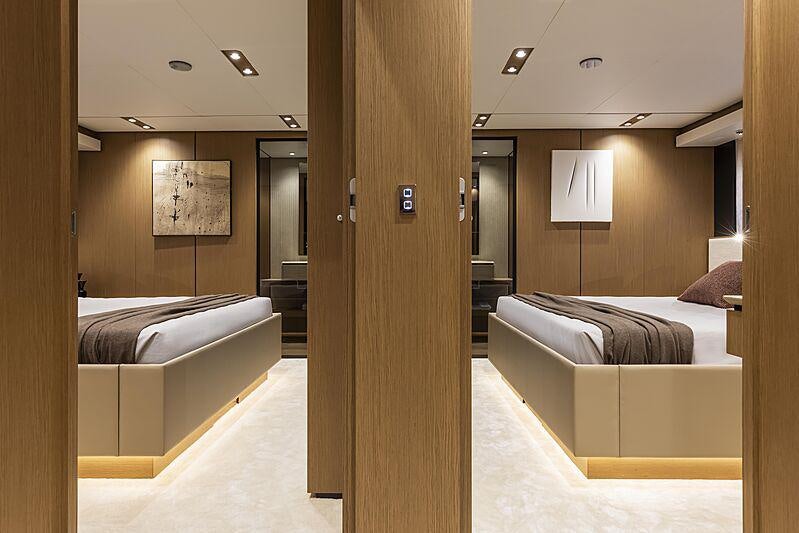 a room with a couple of beds aboard EPIC Yacht for Charter