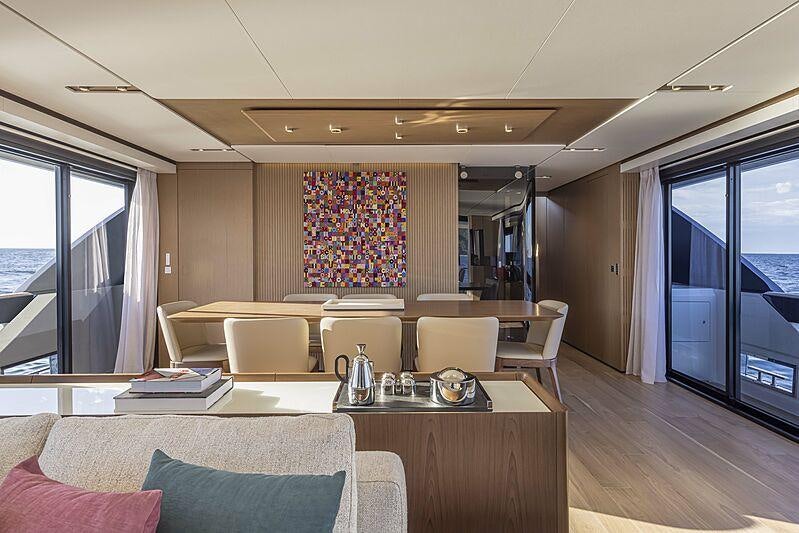 a living room with a large window aboard EPIC Yacht for Charter