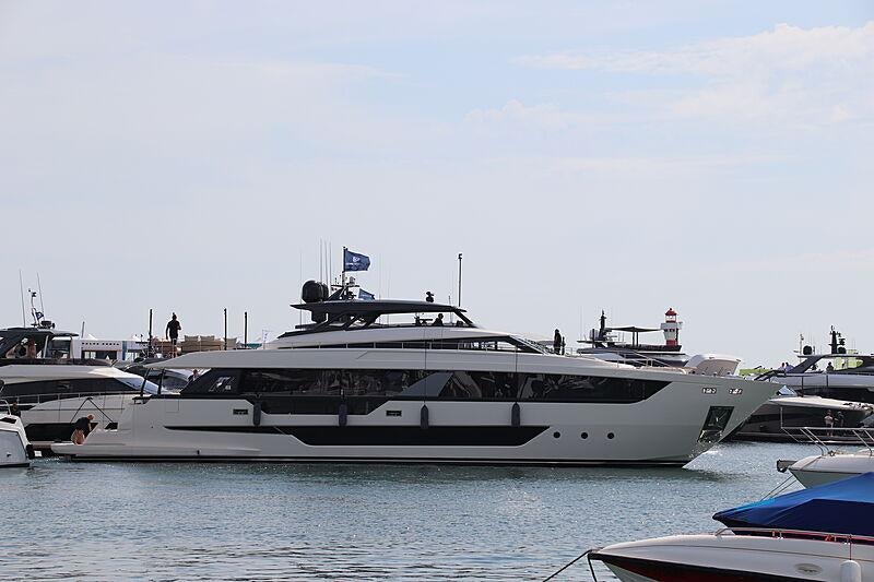 a large white yacht in a harbor aboard EPIC Yacht for Charter