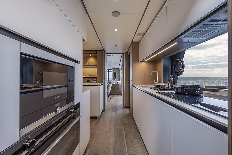 a kitchen with a large window aboard EPIC Yacht for Charter