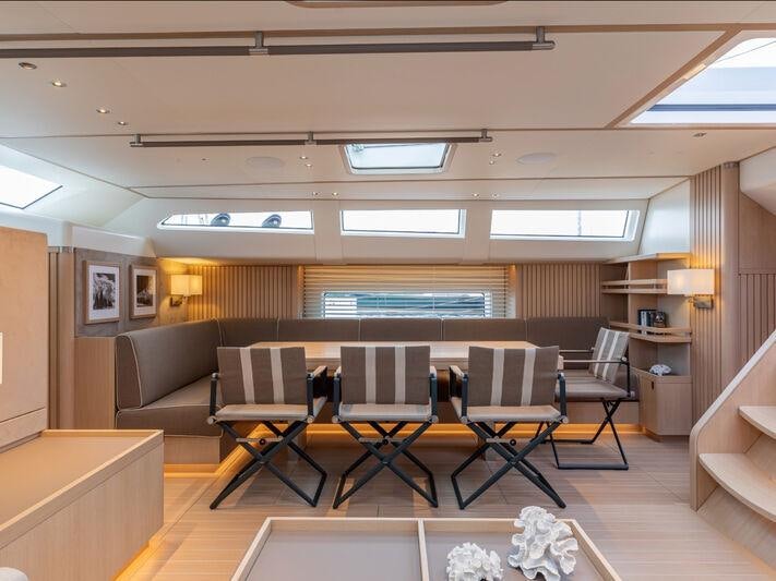 a room with a table and chairs aboard ALIX Yacht for Sale