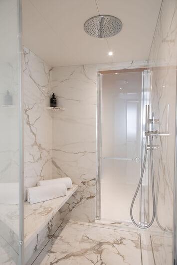 a bathroom with a glass shower aboard LEGEND Yacht for Charter