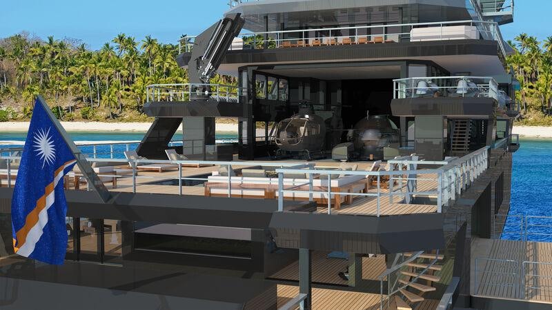 a deck with a flag and a building in the background aboard OCEAN FALCON Yacht for Sale