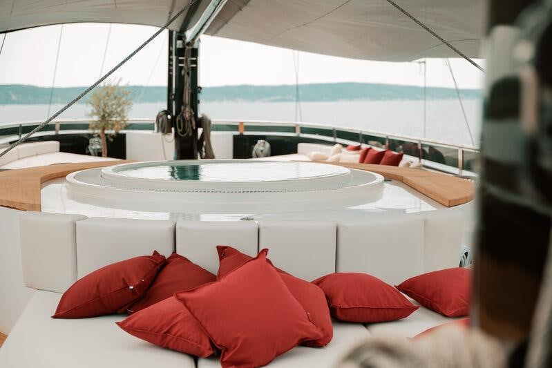 a table with red pillows aboard REPOSADO Yacht for Charter