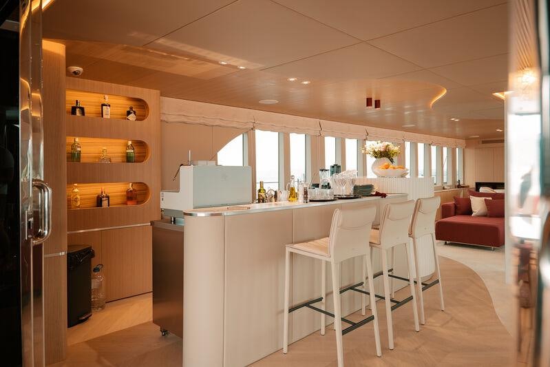 a kitchen with a white table and chairs aboard REPOSADO Yacht for Charter