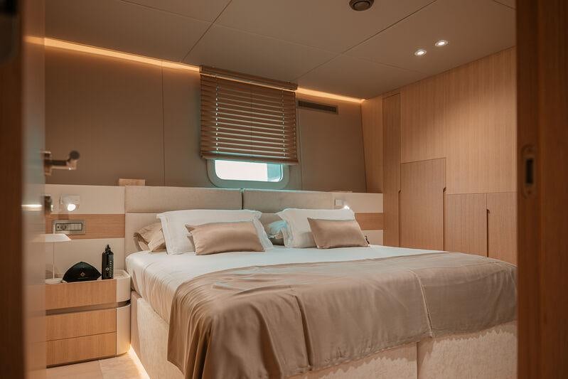 a bed with a white bed spread aboard REPOSADO Yacht for Charter