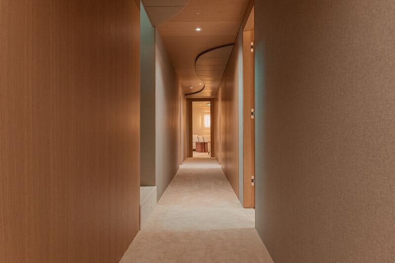 a hallway with a door and a hallway aboard REPOSADO Yacht for Charter
