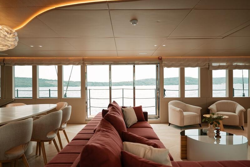 a living room with a red couch aboard REPOSADO Yacht for Charter