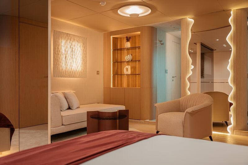 a bedroom with a bed and a table aboard REPOSADO Yacht for Charter