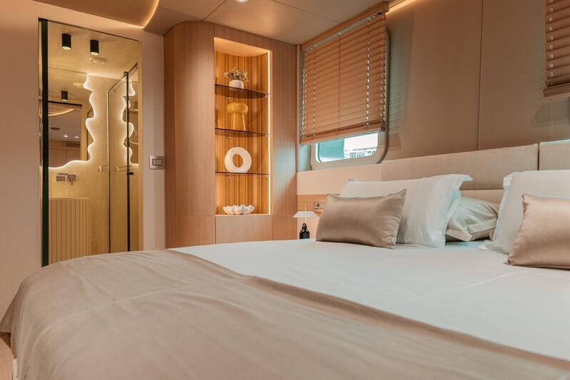 a bed with white sheets aboard REPOSADO Yacht for Charter