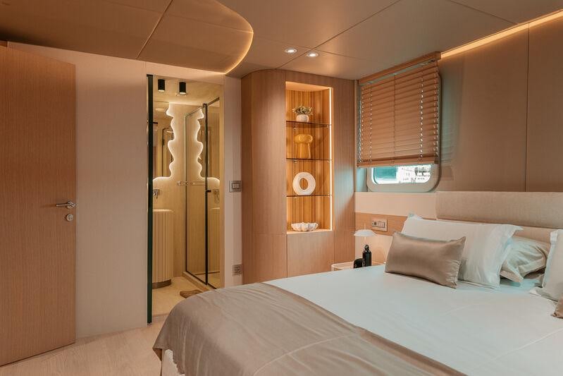 a bedroom with a bed and a closet aboard REPOSADO Yacht for Charter