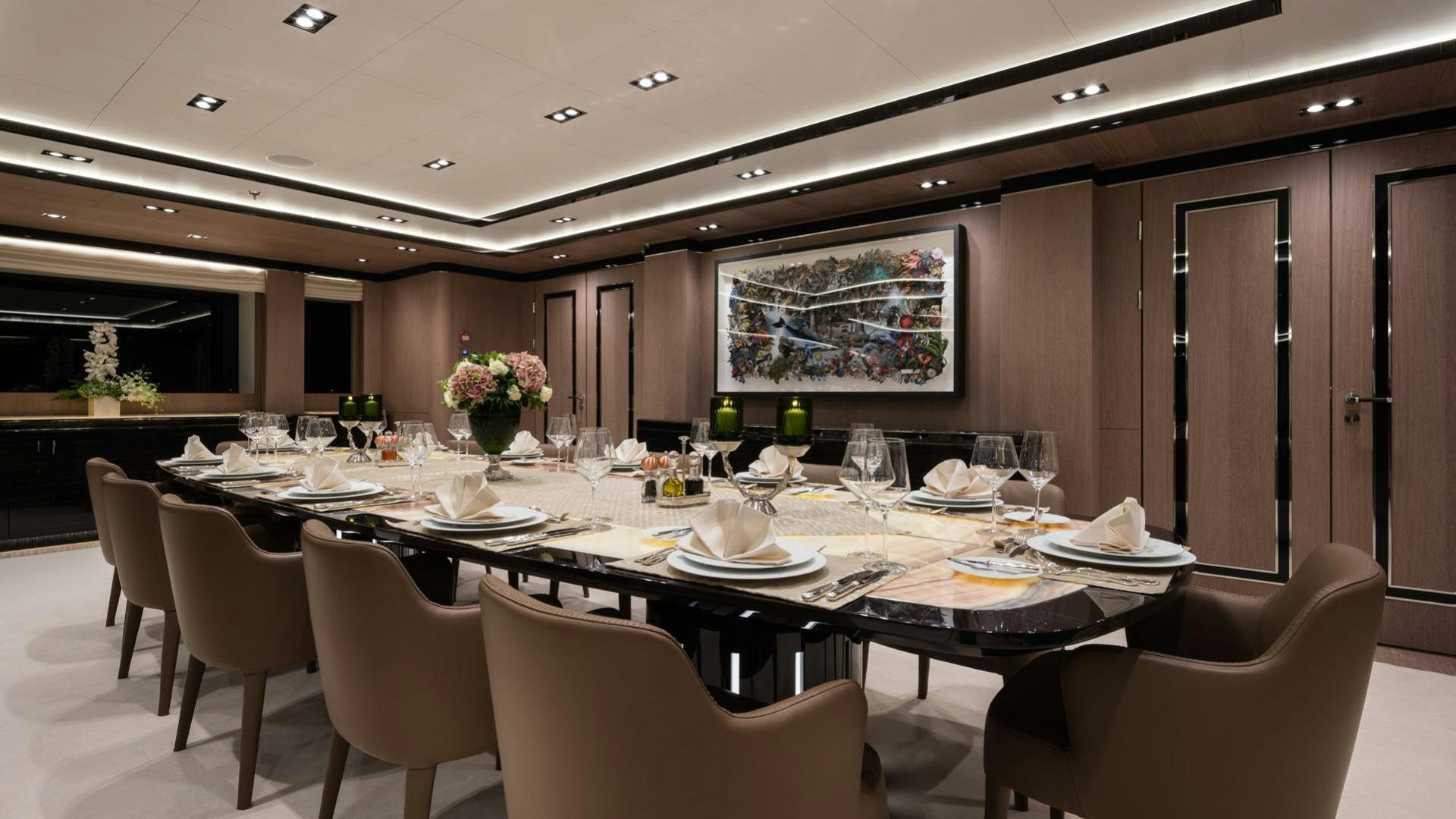 a large dining table with white chairs aboard O'PTASIA Yacht for Charter