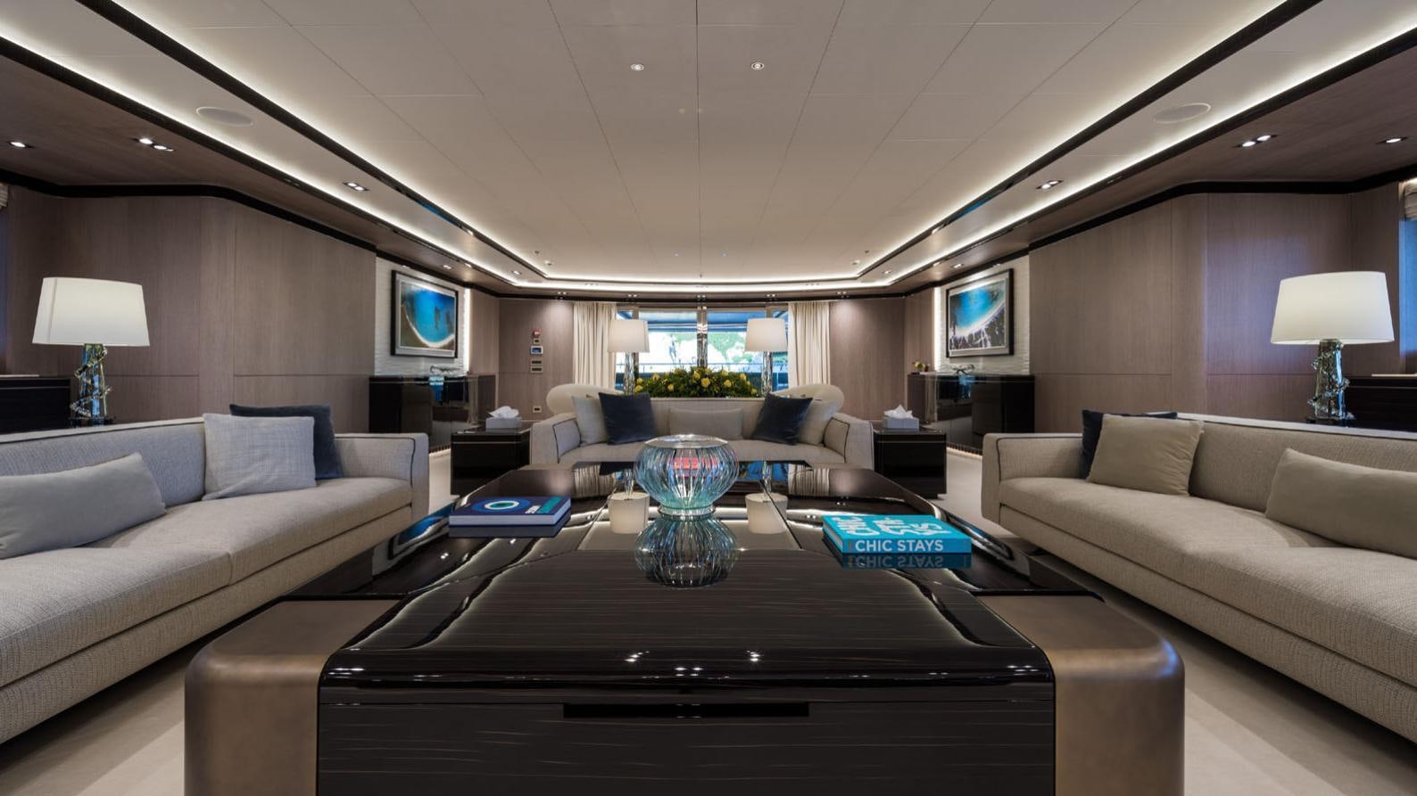 a living room with a large sofa and a coffee table aboard O'PTASIA Yacht for Charter