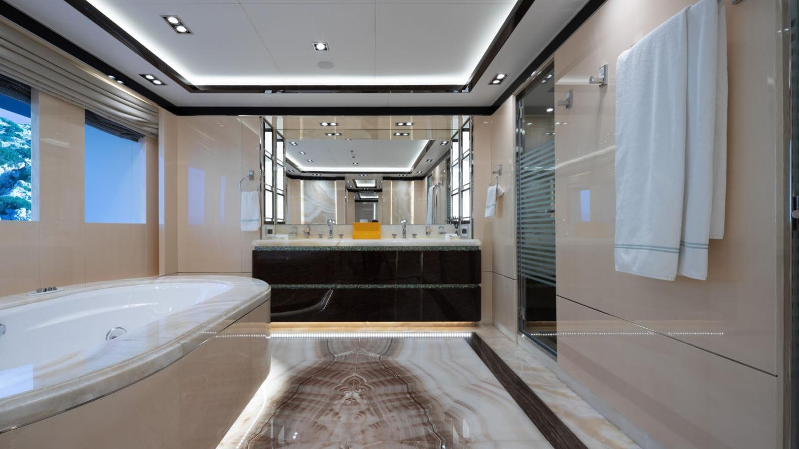 a bathroom with a tub and a shower aboard O'PTASIA Yacht for Charter