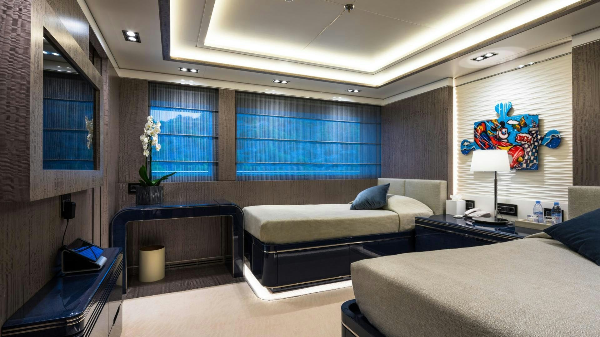a room with a bed and a desk aboard O'PTASIA Yacht for Charter