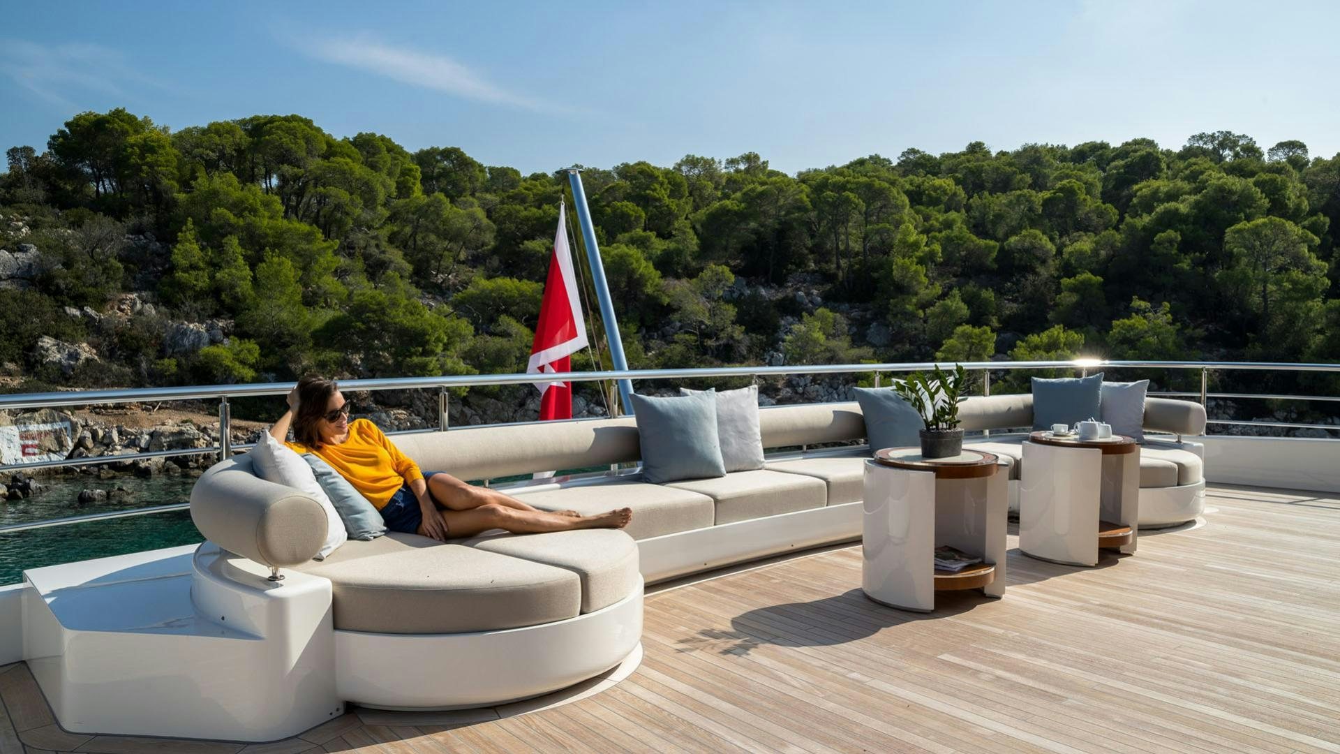 a person sitting on a couch aboard O'PTASIA Yacht for Sale